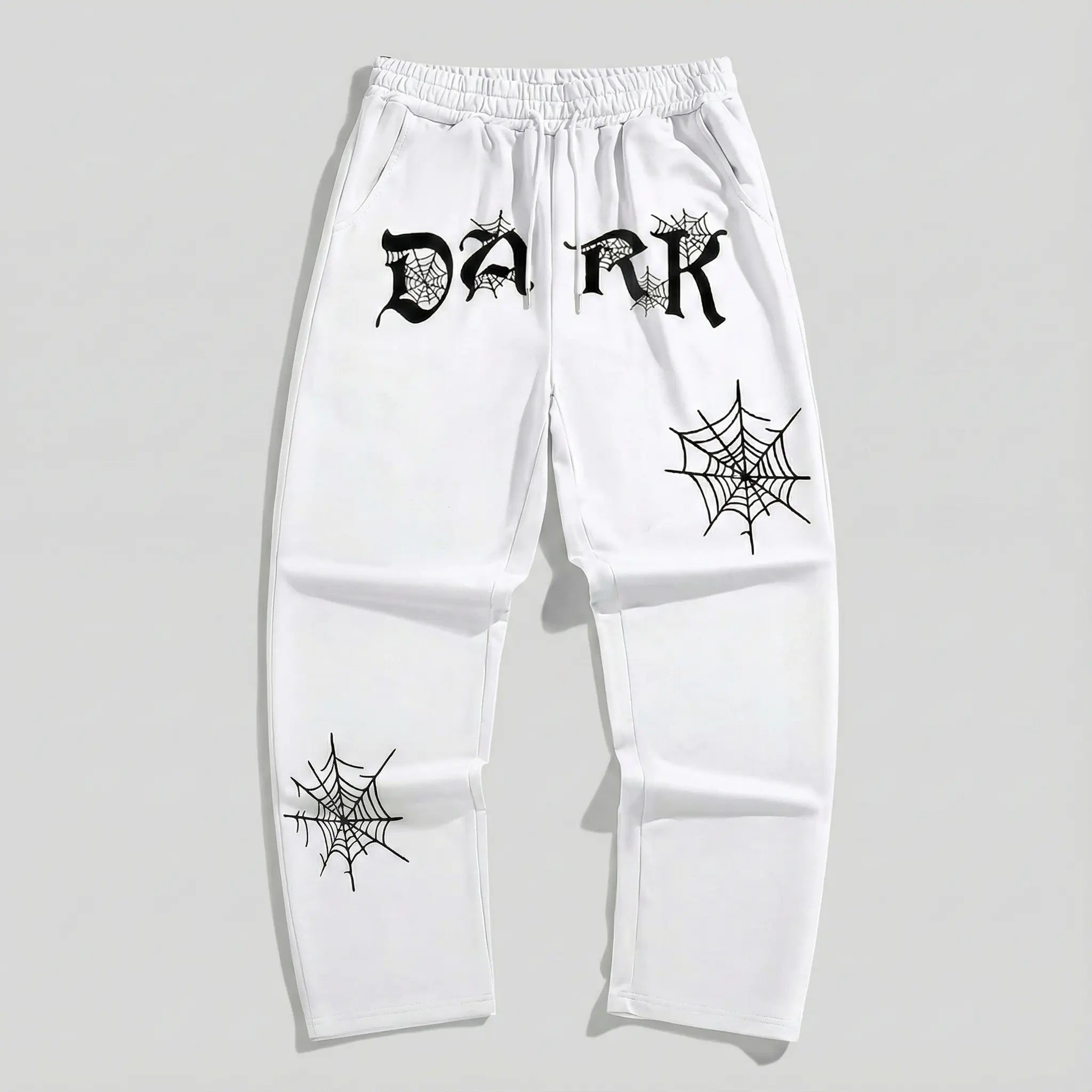 White streetwear sweatpants with black 'DARK' lettering and spiderweb graphic prints