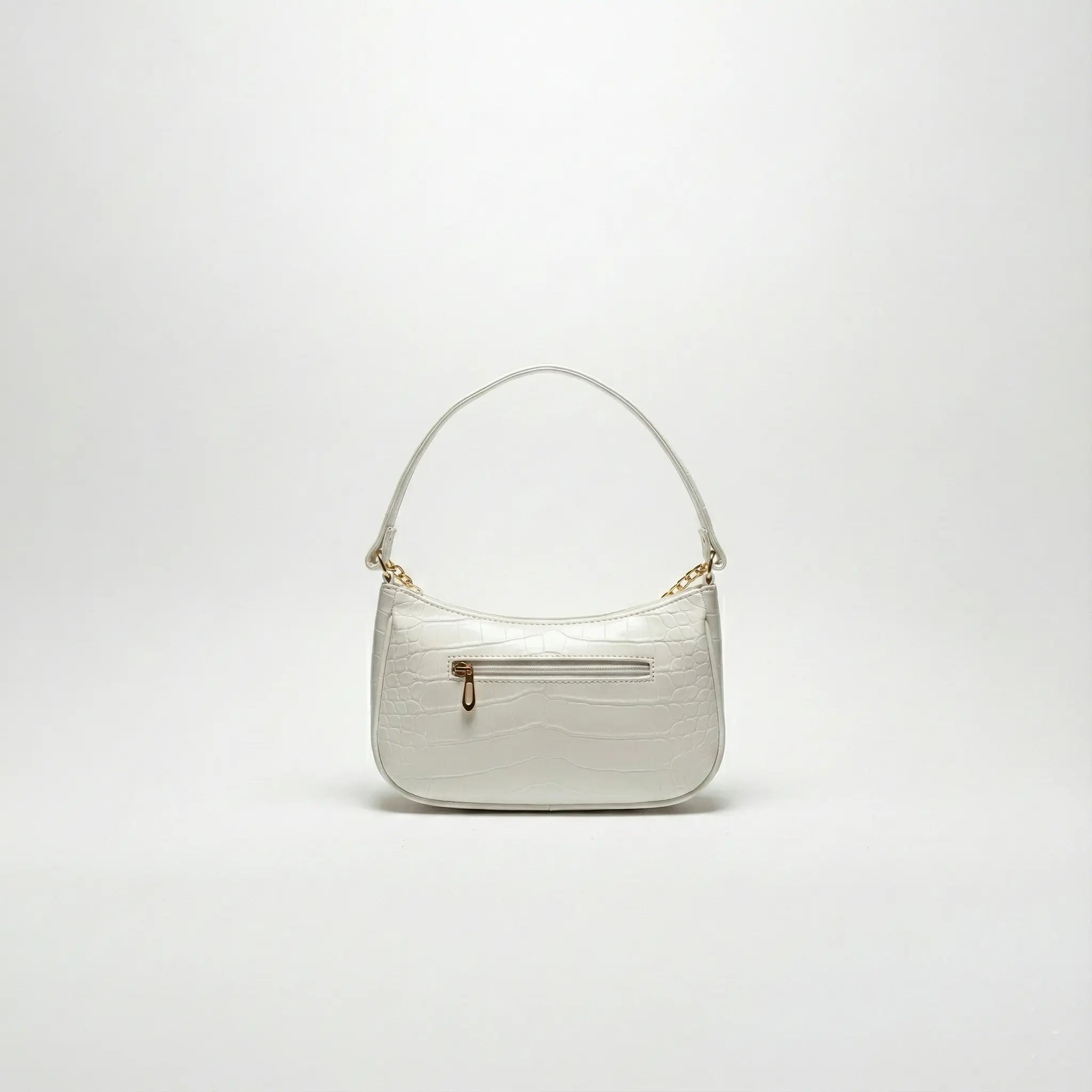 White faux crocodile shoulder bag with gold chain accents and front zipper pocket
