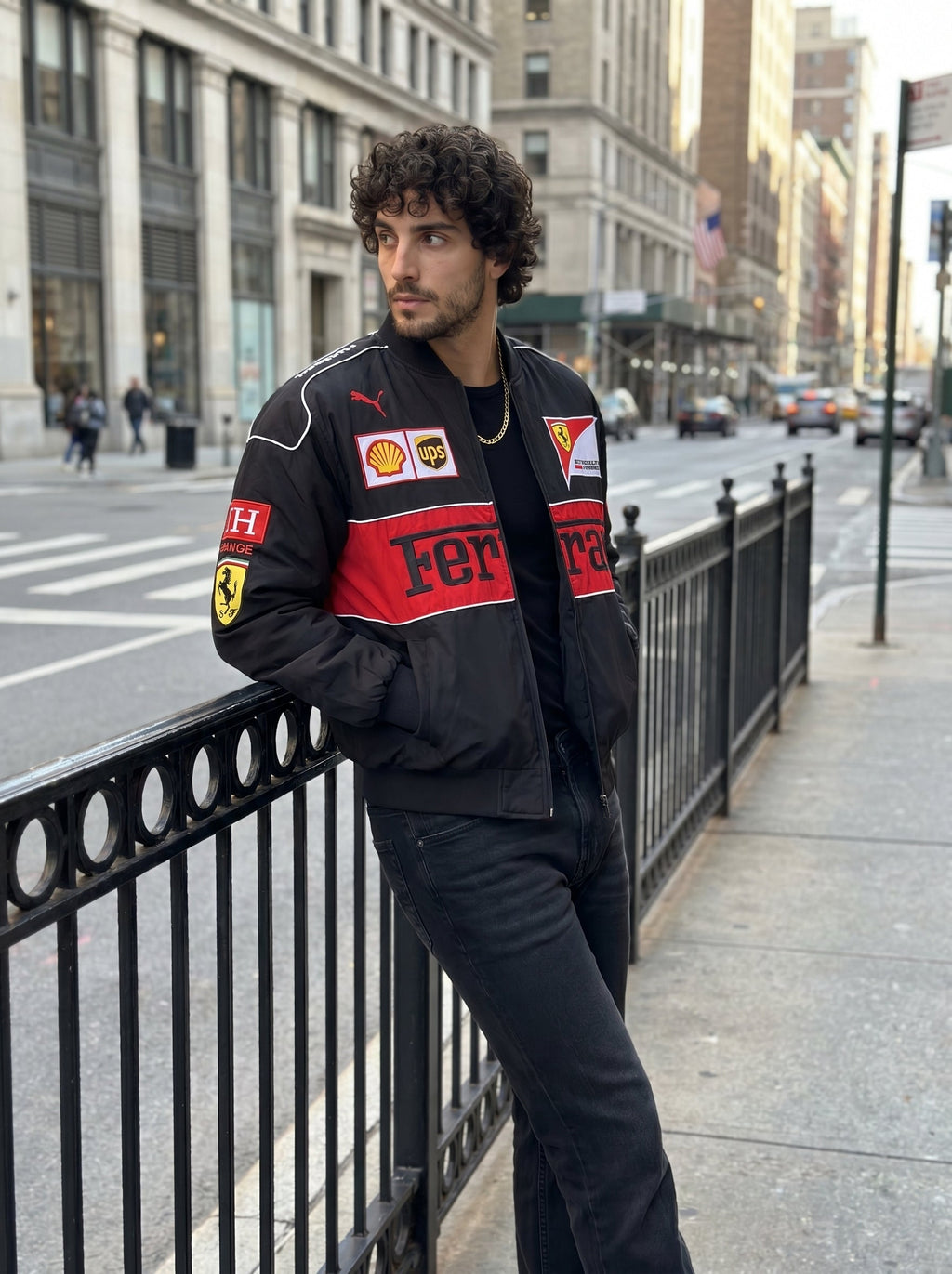 Male model wearing the Eclatte Ferrari Racing Jacket on a city street, showcasing a modern urban streetwear look with F1 branding.