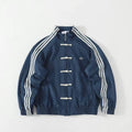 Blue track jacket with white stripes, toggle buttons, and embroidered logo on chest. Chinese New Year Suede Track Jacket – Premium Festive Streetwear
