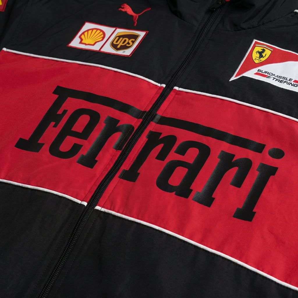Black and red Ferrari jacket with various logos on a close-up view